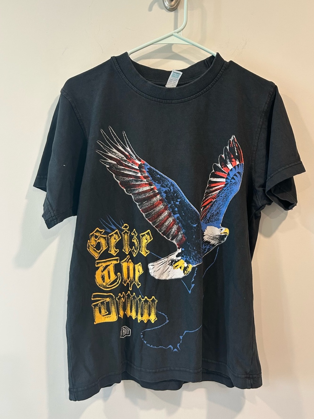 Seven7 Black Tee with Red & Blue Eagle and Yellow Script Seize the drum